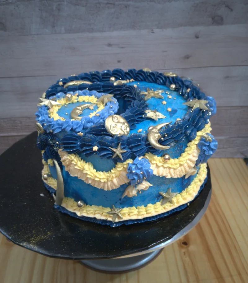 Deep blue buttercream cake with gold moons and stars