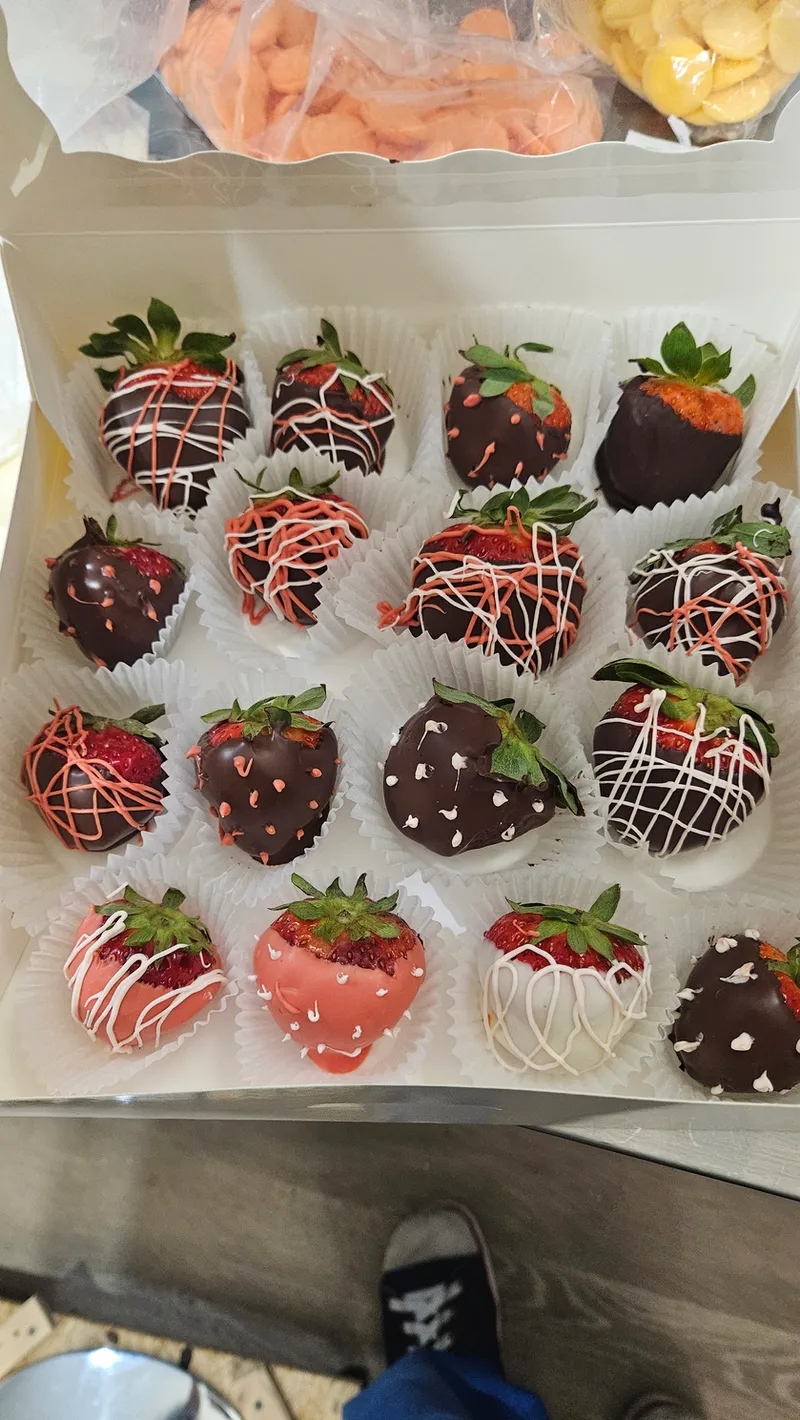 Box of chocolate-covered strawberries drizzled in white and pink