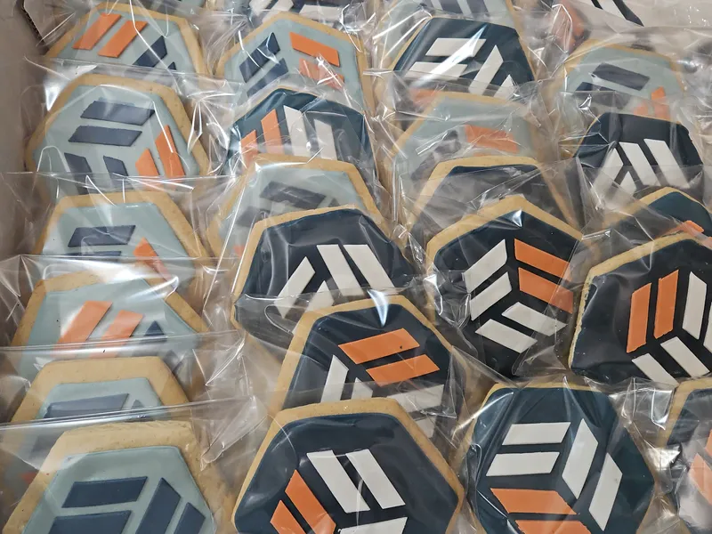 Logo cookies in navy, orange and white, individually heat-sealed