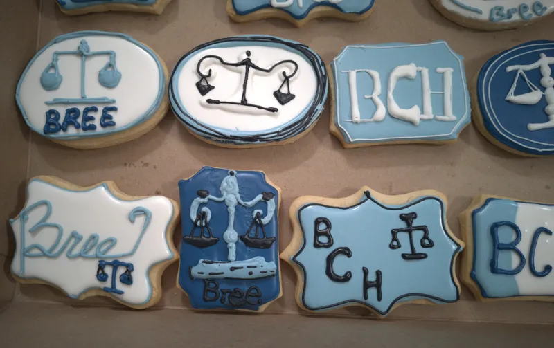 Blue and white cookies with scales of justice and a monogram